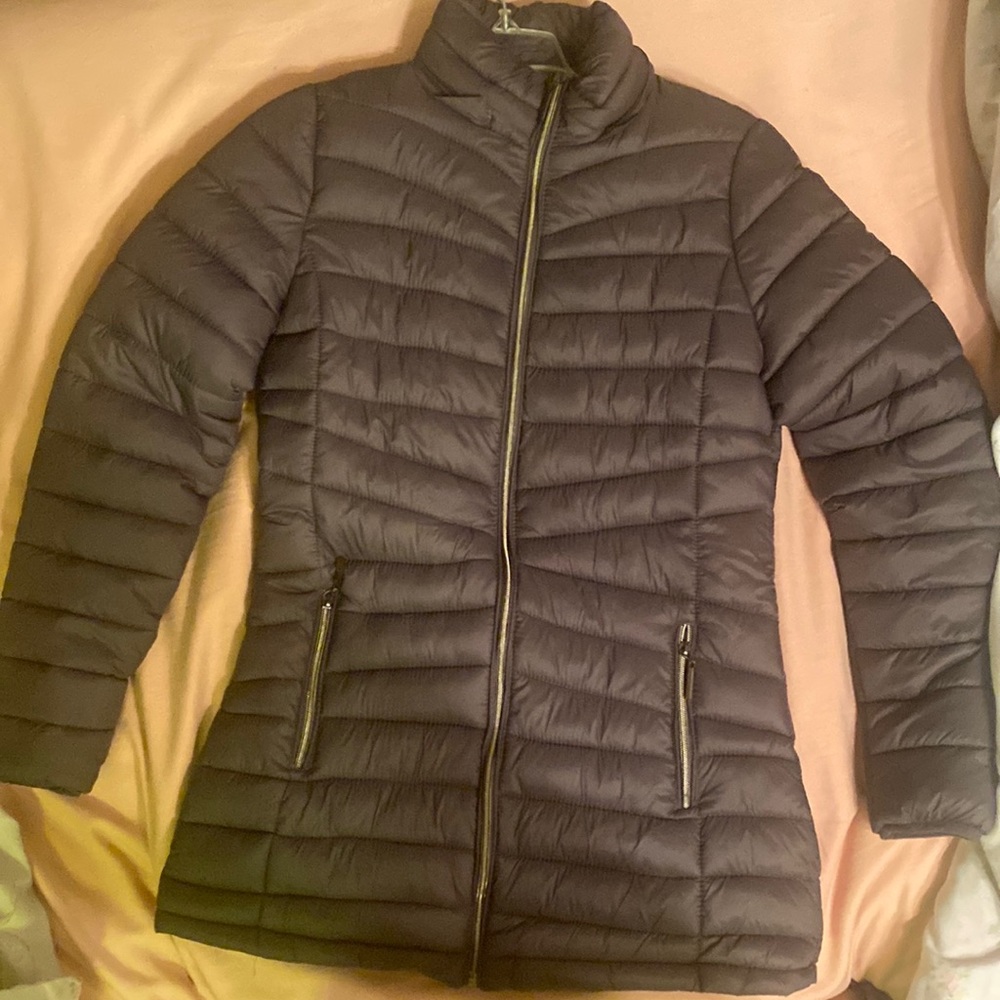 Its a grey puffer jacket with a detachable zipper hoodie with fur around the rim